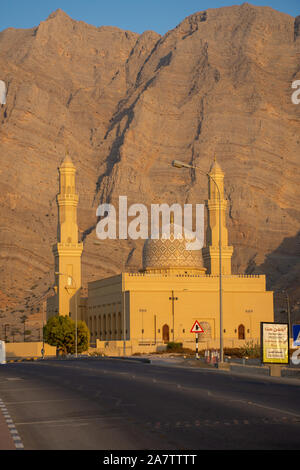 Sultan Qaboos moschea di Bukha, Musandam, Oman al tramonto con le belle montagne e il cielo azzurro in background. Foto Stock