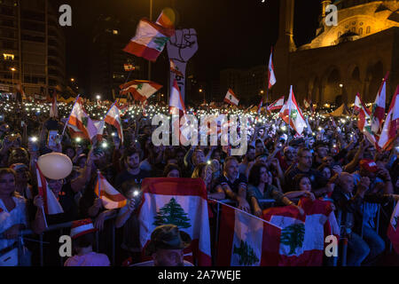 Beirut, Libano. 3 Novembre, 2019. Manifestanti alzare i loro telefoni cellulari seguenti canti politici chiedono una modifica al settario basata su sistema politico in Libano. I dimostranti si sono riuniti per il diciottesimo giorno nel centro di Beirut in migliaia. Domenica 3 novembre 2019 Credit: Sima Diab/ZUMA filo/Alamy Live News Foto Stock