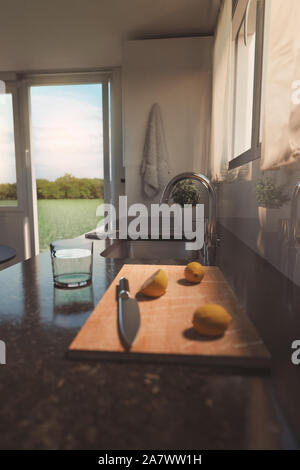 3D rendering di nera pietra naturale piano di lavoro della cucina moderna con limoni e coltello sulla tavola di legno Foto Stock
