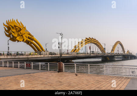 Da Nang, Vietnam - Marzo 10, 2019: estremità di coda di Cau Rong o Dragon ponte sul Fiume Han sotto il mattino cielo blu. Il traffico sul ponte. Foto Stock