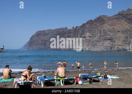 I turisti sulla spiaggia di Los Guios dalle scogliere di Los Gigantes, Tenerife, Isole Canarie, Spagna Foto Stock