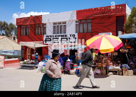 La gente a piedi nella parte anteriore del Perù edificio doganale sul confine Peru-Bolivia vicino a Puno Foto Stock