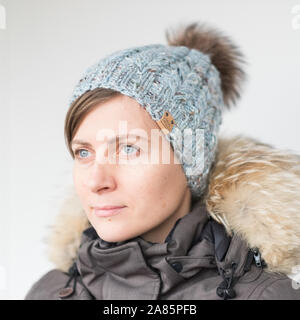 Piuttosto giovane donna che indossa un cappello con il POM Foto Stock