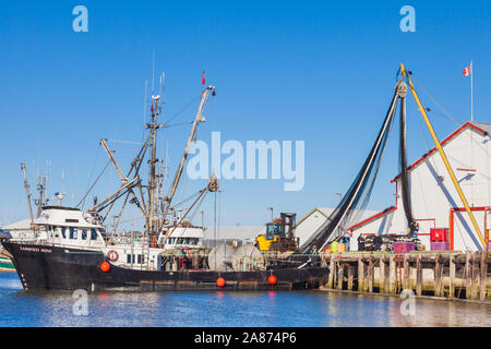 Rimozione di una sciabica net da un commerciale nave da pesca per lo storage a un dock di Steveston British Columbia Foto Stock