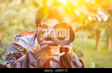 Fotografo Papparazi fotografare in natura con la fotocamera Foto Stock