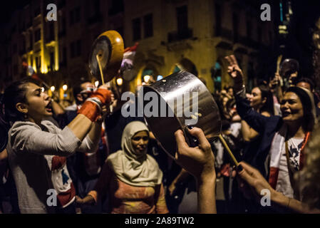 I dimostranti prendere per le strade per un ventiduesimo giorno consecutivo a Beirut, in Libano. Un battito di pentole e tegami e drumming su costruzioni di metallo cartelloni fino a quando il rumore è assordante, stanno rendendo molto chiaro che essi non stanno dando fino a quando non si sentono. Foto Stock