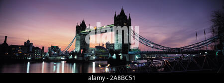 Ponte levatoio accesa fino al tramonto, il Tower Bridge, il fiume Tamigi, Londra, Inghilterra Foto Stock