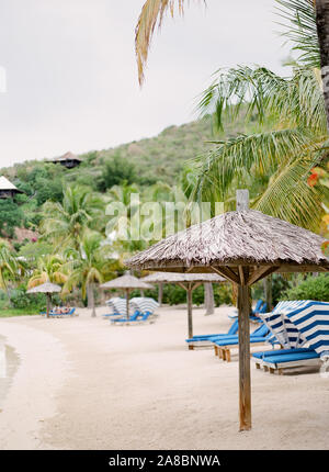Palm frond ombrelloni da spiaggia Al Bitter End Yacht Club su Virgin Gorda isola, Isole Vergini Britanniche, Isole dei Caraibi Foto Stock