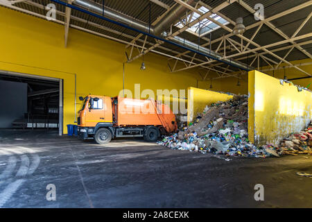 Carrello getta immondizia alle moderne di smistamento del riciclo dei rifiuti nello stabilimento di trasformazione. Separare e smistamento di garbage collection. Riciclaggio e stoccaggio di rifiuti per f Foto Stock