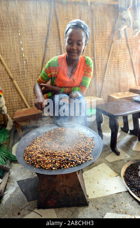 Una giovane donna etiope la tostatura i chicchi di caffè in preparazione del tradizionale caffè etiope. Foto Stock