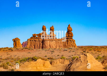 Questa è una vista di alcuni "goblin" noti come le tre sorelle all'ingresso per il parco statale Goblin Valley vicino a Hanksville, Utah, Stati Uniti d'America. Foto Stock