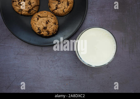 I cookie di latte biscotti con scaglie di cioccolato vista superiore sfondo scuro Foto Stock