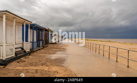 Nuvole grigio sopra la spiaggia di capanne in Sandilands, Lincolnshire, England, Regno Unito Foto Stock