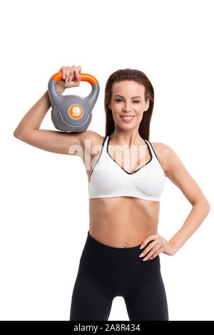 Giovane donna sportivo azienda kettlebell sulla spalla, isolato su bianco Foto Stock