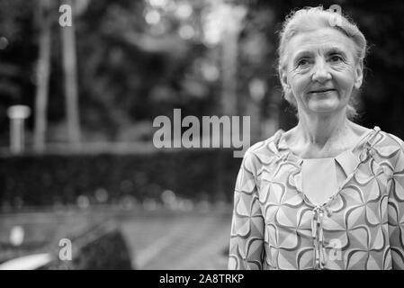 Bella turista senior donna relax intorno alla città in bianco e nero Foto Stock