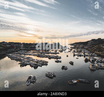 Vista del porto di Ilulissat giorno soleggiato durante il tramonto sunrise. In primo piano è una marina con barche. Foto scattata in Groenlandia Foto Stock