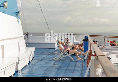 LIVORNO, Italia - Luglio 12, 2019: ai passeggeri di viaggiare sul ponte della nave Moby Vincent nave traghetto all'alba, Livorno in background. Moby è un italiano shippi Foto Stock