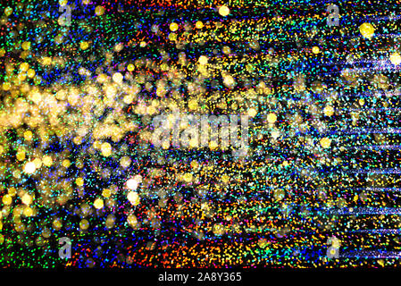 Foto di olografica texture reali nei colori dell'arcobaleno, colorato scintillante superficie iridescente. Colore olografico foil. Glitter colorati. Sfondo luminoso. Foto Stock