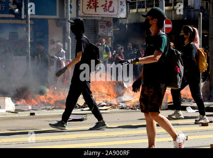 Hong Kong. Xi Nov, 2019. I manifestanti avevano appiccato il fuoco a paralizzare il traffico in Sai Wan Ho, a sud della Cina di Hong Kong, nov. 11, 2019. Dopo la paralisi del traffico su Hong Kong durante la mattina Rush Hour, rivoltosi mantenuta escalation della violenza in varie posizioni su lunedì da lanciare bombe molotov a campus universitari e nelle stazioni della metropolitana e a ledere i residenti che non concordo con loro, anche l'impostazione di un passante variopinte. Credito: Xinhua/Alamy Live News Foto Stock