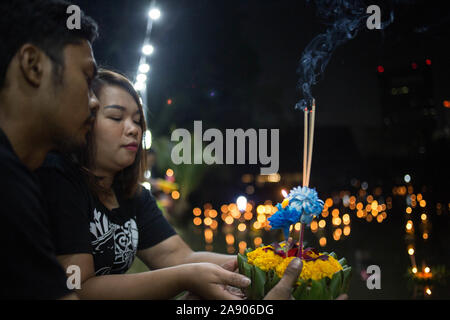 Bangkok, Tailandia. Xi Nov, 2019. Un paio di pregare prima di rilasciare una Kratong in uno stagno per contrassegnare Loy Kratong Festival in Bangkok.rilasciando piccole lanterne "Kratong' nello stagno o fiume, tailandese provenienti da tutto il paese portare omaggio alla dea di acqua mentre si scusa per l'inquinamento dei fiumi. Credito: SOPA Immagini limitata/Alamy Live News Foto Stock