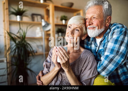 Felice romantico coppia senior abbracciando e godendo della pensione a home Foto Stock