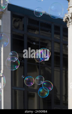 Le bolle create da un suonatore ambulante / street performer , di fronte alla National Gallery, Trafalgar Square, London, Regno Unito Foto Stock