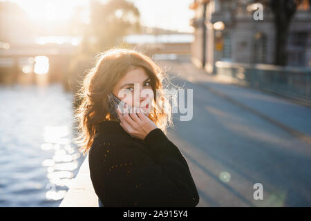 Donna sorridente al telefono Foto Stock