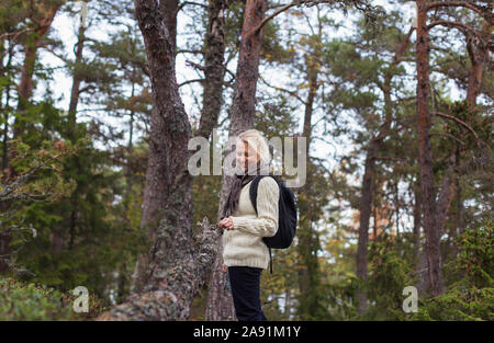 Donna sorridente in foresta Foto Stock