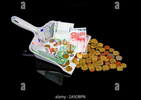 Euro Geld in einer Kehrschaufel, und Münzen Banknoten, Foto Stock