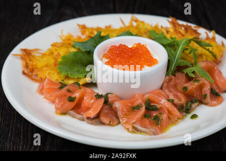 frittelle di patate, pesce di salmone e caviale rosso Foto Stock