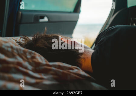 Persona che dormiva in auto Foto Stock