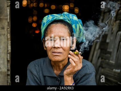 Donna anziana che fuma un cheroot; Taungyii, Stato Shan, Myanmar Foto Stock