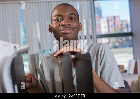 Ritratto di afroamericano con autismo che lavora in un ufficio Foto Stock
