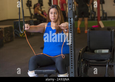 Donna con lesione del midollo spinale che lavora in palestra Foto Stock