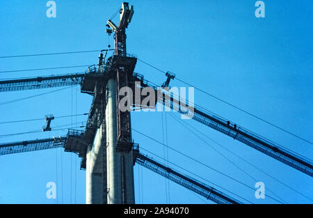 Il ponte Humber in costruzione, 1979. Le gru in cima ad una delle torri. Vicino a Kingston Upon Hull, Yorkshire, Inghilterra, Regno Unito Foto Stock