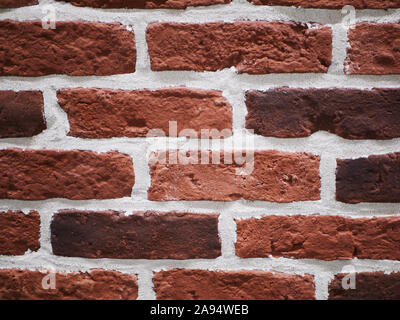 Orange facciata in mattoni. Strappata texture di pietra. Muro di pietra. sfondo astratto Foto Stock