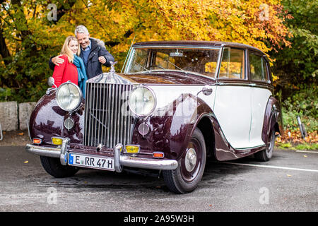 13 novembre 2019, Renania settentrionale-Vestfalia, Essen: i modelli Anja e Martin stare accanto a una Rolls Royce Silver Wraith Sedanca dal 1949 vicino al casino di caccia Schellenberg. Motor Show di Essen ha luogo quest'anno dal 30.11. al 08.12.. Foto: Marcel Kusch/dpa Foto Stock