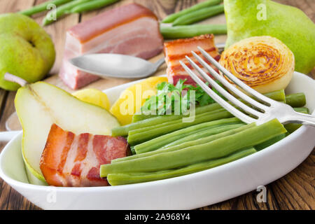 Il tedesco hotpot con fagiolini, pere e pancetta Foto Stock