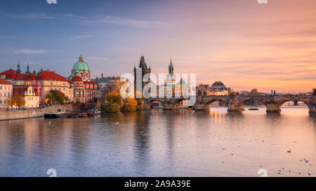 Praga, Repubblica Ceca. Paesaggio urbano panoramica immagine del famoso Ponte Carlo a Praga durante il bellissimo tramonto d'autunno. Foto Stock