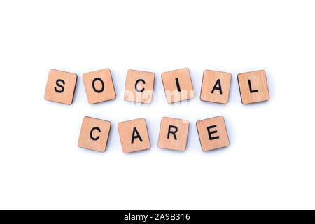 Assistenza sociale, farro con lettera in legno piastrelle. Foto Stock