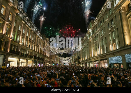 Regent Street, Londra, Regno Unito. Xiv Nov, 2019. Fuochi d'artificio accompagnare l'accensione delle luci. Il Natale più grande installazione di luce a Londra, Regent Street di 'lo spirito di Natale', dotate di angeli illuminato diffondere le loro ali, viene accesa con un programma di palcoscenico, esecutori, attività di festa, cibo e bevande. Credito: Imageplotter/Alamy Live News Foto Stock