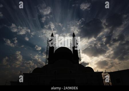 Kuwait City/Kuwait - 10/10/2019: moschea sotto la costruzione di minareti in impalcature stagliano contro un cielo nuvoloso Foto Stock