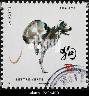 La verniciatura del cane di zodiaco cinese sul francobollo Foto Stock