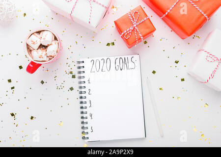 Nuovo anno risultati. Gli obiettivi 2020 della scrittura nel notebook Foto Stock