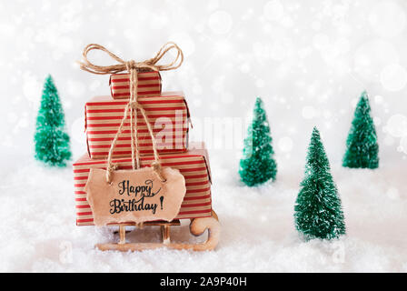 Sled, presente, neve Happy Birthday, sfondo grigio Foto Stock