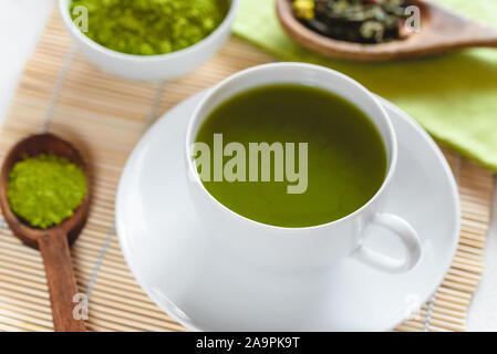 Il tè verde Matcha in una tazza bianca Foto Stock