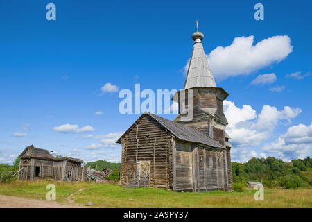 Vista del vecchio Ilyinskaya in legno chiesa e le rovine della chiesa di Tikhvin Icona della Madre di Dio su una soleggiata giornata d agosto. Il villaggio di Sa Foto Stock