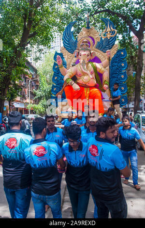 Uomini indiani che carring Ganesh idol durante il festival di Ganesh Chaturthi in Mumbai India Foto Stock