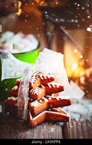 Festosa fatti a mano gingerbread cookie sotto forma di stelle per il Natale e il nuovo anno di vacanza su una tavola di legno. Verticale. Foto Stock