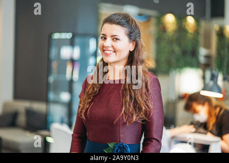 Affascinante giovane donna sorridente proprietario del salone di bellezza nail bar, il concetto di una piccola impresa Foto Stock